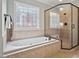 Bright bathroom with a soaking tub and tiled glass shower at 7906 Longleaf Branch Ct, Raleigh, NC 27612