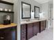 Bathroom featuring double sink vanity with dark wood cabinets and granite countertops at 7906 Longleaf Branch Ct, Raleigh, NC 27612