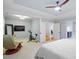 Spacious bedroom boasts a ceiling fan, exercise bike, and sitting area at 7906 Longleaf Branch Ct, Raleigh, NC 27612