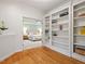 Open view to bedroom showing built-in bookcases and hardwood floors at 7906 Longleaf Branch Ct, Raleigh, NC 27612