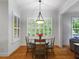Bright breakfast nook features hardwood floors, white trim and a charming light fixture at 7906 Longleaf Branch Ct, Raleigh, NC 27612