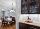 Charming butler's pantry with upper display cabinets and granite counters at 7906 Longleaf Branch Ct, Raleigh, NC 27612