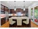 Modern kitchen with a large center island, stainless steel appliances, and barstool seating at 7906 Longleaf Branch Ct, Raleigh, NC 27612