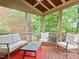 Cozy screened-in porch with comfortable seating, a wood ceiling, and wooded views at 7906 Longleaf Branch Ct, Raleigh, NC 27612