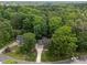 Aerial view of a brick home featuring mature trees and a circular driveway at 8004 Gabriels Bend Dr, Raleigh, NC 27612