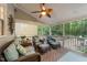 Relaxing back porch featuring comfortable seating, a ceiling fan, and views of the wooded backyard at 8004 Gabriels Bend Dr, Raleigh, NC 27612