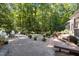 Spacious backyard featuring a stone patio, mature trees, and inviting outdoor spaces at 8004 Gabriels Bend Dr, Raleigh, NC 27612