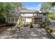 A stone patio and lush backyard create an inviting outdoor space with mature trees at 8004 Gabriels Bend Dr, Raleigh, NC 27612