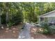 Home exterior boasting a stone tile walkway, leading to a covered porch and a beautiful outdoor landscape at 8004 Gabriels Bend Dr, Raleigh, NC 27612
