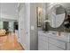 Powder room with traditional vanity and mirror, with doorway leading to the living room at 8004 Gabriels Bend Dr, Raleigh, NC 27612