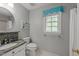 Updated bathroom with granite countertop vanity, round mirror, and decorative wall art at 8004 Gabriels Bend Dr, Raleigh, NC 27612
