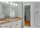Bright bathroom features a double sink vanity with granite countertops and a view of the shower area at 8004 Gabriels Bend Dr, Raleigh, NC 27612