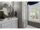 Clean, gray bathroom featuring a glass shower and a modern vanity with sink and chrome fixtures at 8004 Gabriels Bend Dr, Raleigh, NC 27612