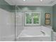 Bathroom features a large soaking tub with shower and a window offering a view to the beautiful outdoors at 8004 Gabriels Bend Dr, Raleigh, NC 27612