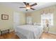 Charming bedroom features a ceiling fan, wood floors, a large window, and cozy decor at 8004 Gabriels Bend Dr, Raleigh, NC 27612