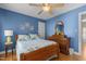 Comfortable bedroom features wooden furniture, a ceiling fan, and calming blue walls at 8004 Gabriels Bend Dr, Raleigh, NC 27612