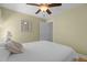 Well-lit bedroom features a ceiling fan, wood floors, and a door leading to an adjoining area at 8004 Gabriels Bend Dr, Raleigh, NC 27612