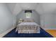 Attic bedroom with a cozy atmosphere featuring symmetrical design and blue accents at 8004 Gabriels Bend Dr, Raleigh, NC 27612
