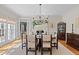 Elegant dining room with a fireplace, hardwood floors, and ample natural light at 8004 Gabriels Bend Dr, Raleigh, NC 27612