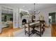 Elegant dining room with hardwood floors, modern chandelier and a doorway to the living room at 8004 Gabriels Bend Dr, Raleigh, NC 27612