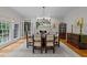Stylish dining room featuring hardwood floors, a modern chandelier, and direct access to an adjacent room at 8004 Gabriels Bend Dr, Raleigh, NC 27612