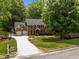 Beautiful brick home featuring a three-car garage, mature trees, and meticulously landscaped yard at 8004 Gabriels Bend Dr, Raleigh, NC 27612