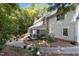 Two story home featuring a brick chimney, a screened porch and a brick patio surrounded by lush green trees at 8004 Gabriels Bend Dr, Raleigh, NC 27612