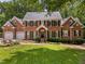 Traditional brick home with black shutters, well-maintained landscaping, and a two-car garage at 8004 Gabriels Bend Dr, Raleigh, NC 27612