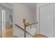 Hallway features wooden stairs, white walls and trim, complemented by a classic two-door closet at 8004 Gabriels Bend Dr, Raleigh, NC 27612