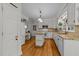 Bright kitchen features an island, granite countertops, and white appliances at 8004 Gabriels Bend Dr, Raleigh, NC 27612