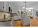 Charming kitchen featuring granite countertops, white cabinets and stainless steel appliances at 8004 Gabriels Bend Dr, Raleigh, NC 27612