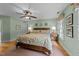 Cozy main bedroom with a ceiling fan, hardwood floors, and two side tables at 8004 Gabriels Bend Dr, Raleigh, NC 27612