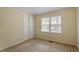 Well-lit bedroom with neutral walls, plush carpet, and closet at 809 Valerie Dr, Raleigh, NC 27606