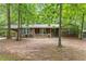 Charming brick home with a cozy front porch and well-maintained landscaping surrounded by mature trees at 809 Valerie Dr, Raleigh, NC 27606