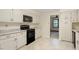 Well-lit kitchen with white cabinets and a range oven offering a functional space at 809 Valerie Dr, Raleigh, NC 27606