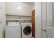 Laundry room with washer, dryer, cabinets, and storage shelves at 809 Valerie Dr, Raleigh, NC 27606