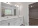 Bathroom with double sink vanity, large mirror, and neutral color palette at 815 Harmony Ranch Ln, Franklinton, NC 27525