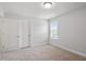 This bedroom offers neutral carpeting, a large window, and white walls at 815 Harmony Ranch Ln, Franklinton, NC 27525