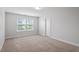 This bedroom offers neutral carpeting, two large windows, and white walls at 815 Harmony Ranch Ln, Franklinton, NC 27525