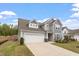 Charming two-story home with a two-car garage and well-manicured front lawn at 815 Harmony Ranch Ln, Franklinton, NC 27525