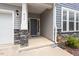 Inviting front porch features stone accents and a stylish front door with house numbers at 815 Harmony Ranch Ln, Franklinton, NC 27525