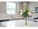 Kitchen with sleek countertops, stylish cabinetry, and natural light from large windows at 815 Harmony Ranch Ln, Franklinton, NC 27525