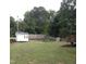 Expansive backyard features a shed, a fire pit with chairs, a wood fence, and a deck at 8600 Colville Ct, Raleigh, NC 27617