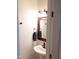 Stylish bathroom with a pedestal sink, framed mirror, and modern fixtures, offering a clean design at 8600 Colville Ct, Raleigh, NC 27617