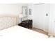 Bedroom with a desk, upholstered headboard, a mirror, and closet at 8600 Colville Ct, Raleigh, NC 27617