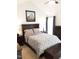 Comfortable bedroom features a stylish patterned comforter, dark wood furniture, and a ceiling fan at 8600 Colville Ct, Raleigh, NC 27617