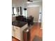 Bright dining area features dark wood table set, modern lighting and a sleek breakfast bar at 8600 Colville Ct, Raleigh, NC 27617