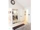 Bright hallway with a full-length mirror reflecting a bedroom with neutral decor and modern furnishings at 8600 Colville Ct, Raleigh, NC 27617
