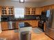 Modern kitchen with stainless steel appliances, granite countertops, and ample cabinet space at 8600 Colville Ct, Raleigh, NC 27617