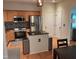 Well-lit kitchen featuring stainless steel appliances, a center island, and hardwood floors at 8600 Colville Ct, Raleigh, NC 27617
